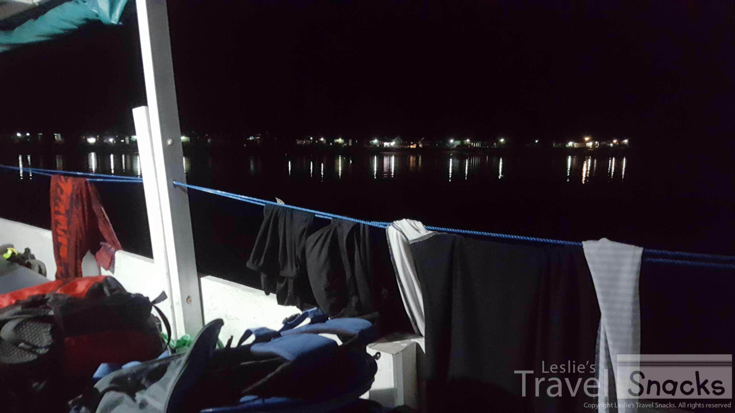 Wet clothing hanging all over the boat. 